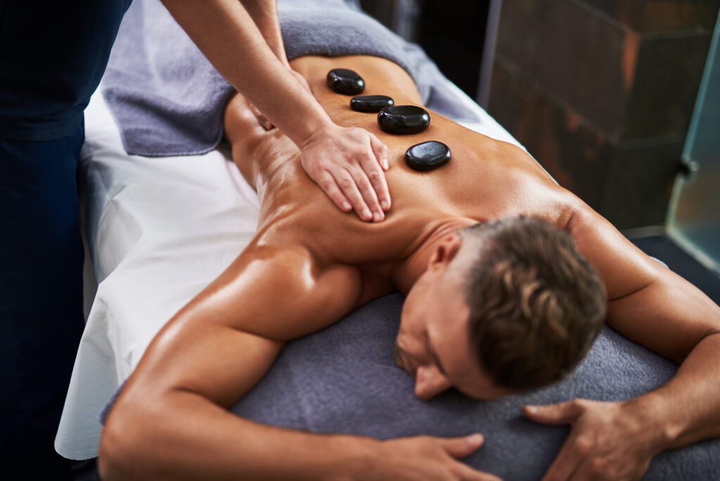 Hot stone massage session for muscle relaxation and circulation